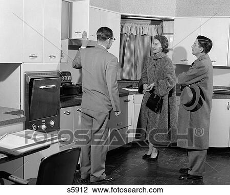 1950S Salesman In Model Kitchen With Couple View Large Photo Image Stock Image - 1950S Salesman In Model Kitchen With Couple . Fotosearch