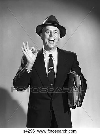 1950S Salesman Man Making Okay Sign With Thumb And Index Finger Carrying Briefcase Wearing Suit Tie And Hat Eager Smiling View Large Photo Image Stock Photograph - 1950S Salesman Man Making Okay Sign With Thumb And Index Finger Carrying Briefcase Wearing Suit Tie And Hat Eager Smiling. Fotosearch