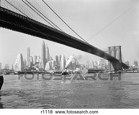 1950S Skyline Of Lower Manhattan With Brooklyn Bridge From Brooklyn Across The East River Tugboat Skyscrapers View Large Photo Image Stock Photo - 1950S Skyline Of Lower Manhattan With Brooklyn Bridge From Brooklyn Across The East River Tugboat Skyscrapers . Fotosearch