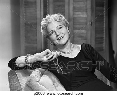 1950S Smiling Fashionable Senior Woman Holding Glasses Wearing Bracelet View Large Photo Image Stock Photograph - 1950S Smiling Fashionable Senior Woman Holding Glasses Wearing Bracelet . Fotosearch