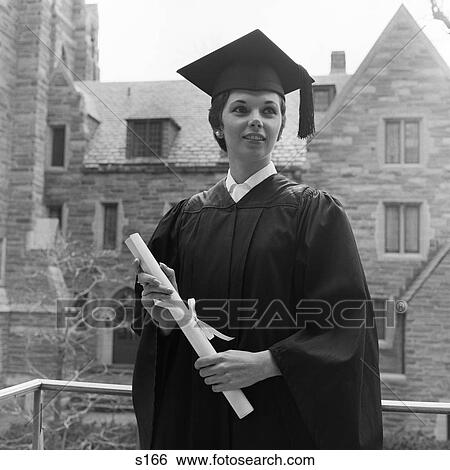 1950S Smiling Female Graduate Holding Diploma With Stone Campus Buildings In Background View Large Photo Image Stock Photograph - 1950S Smiling Female Graduate Holding Diploma With Stone Campus Buildings In Background . Fotosearch
