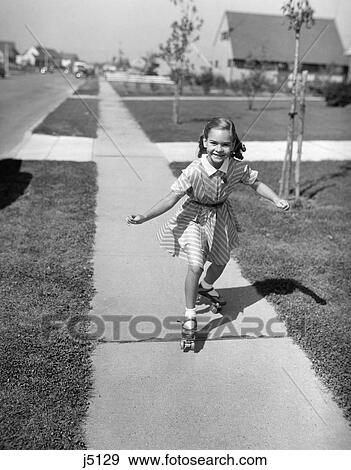 1950S Smiling Girl Roller Skating On Sidewalk Suburban Street View Large Photo Image Stock Photo - 1950S Smiling Girl Roller Skating On Sidewalk Suburban Street . Fotosearch