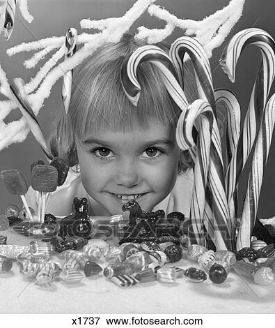 Stock Photo - 1950S Smiling Little Blonde Girl Peek In Window Candy Store Display Eyes Wide . Fotosearch