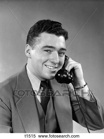Stock Photography - 1950S Smiling Man Suit Tie Talking On Telephone . Fotosearch