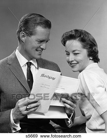 1950S Smiling Portrait Couple Looking At Copy Of New Mortgage View Large Photo Image Stock Photo - 1950S Smiling Portrait Couple Looking At Copy Of New Mortgage . Fotosearch