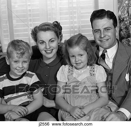 1950S Smiling Portrait Family Of 4 Sitting On Living Room Sofa View Large Photo Image Stock Photograph - 1950S Smiling Portrait Family Of 4 Sitting On Living Room Sofa . Fotosearch