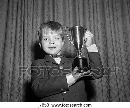 1950S Smiling Proud Boy Holding Up Trophy Award View Large Photo Image Stock Image - 1950S Smiling Proud Boy Holding Up Trophy Award . Fotosearch