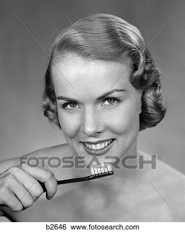 Stock Photograph - 1950S Smiling Woman Holding Tooth Brush . Fotosearch