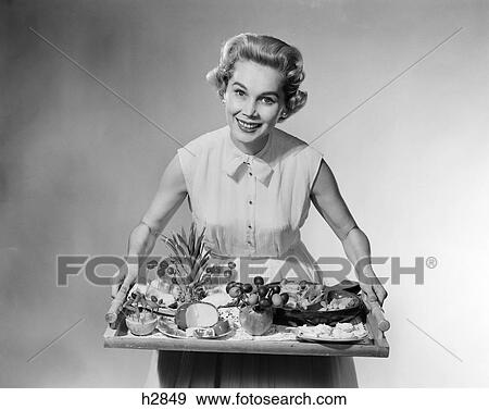1950S Smiling Woman Hostess Holding Tray Of Fruit Chesse Canapes Hors D'Oeuvres Party Food View Large Photo Image Stock Photo - 1950S Smiling Woman Hostess Holding Tray Of Fruit Chesse Canapes Hors D'Oeuvres Party Food . Fotosearch