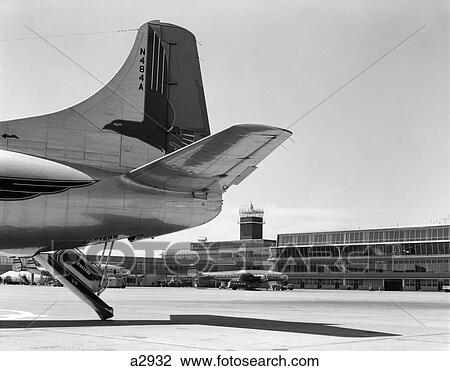 Stock Image - 1950S Tail End Of Airplane With Philadelphia Airport And Other Planes In Background . Fotosearch