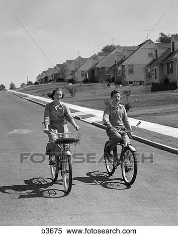 1950S Teen Boy Girl Riding Bikes Suburban Neighborhood Street View Large Photo Image Stock Photography - 1950S Teen Boy Girl Riding Bikes Suburban Neighborhood Street . Fotosearch