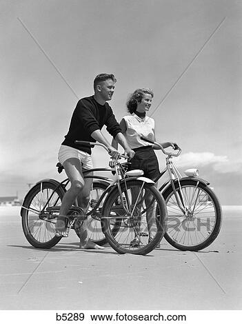 1950S Teenage Boy And Girl With Bikes On The Beach View Large Photo Image Stock Photo - 1950S Teenage Boy And Girl With Bikes On The Beach . Fotosearch