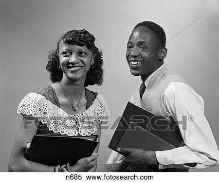 1950S Two Smiling African-American Students Boy Girl Carrying Books Couple View Large Photo Image Stock Photography - 1950S Two Smiling African-American Students Boy Girl Carrying Books Couple . Fotosearch
