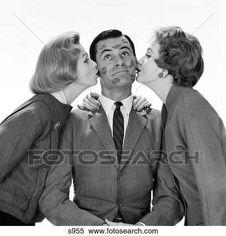 1950S Two Women Kissing Single Man On Opposite Cheeks His Face Covered With Lipstick Marks View Large Photo Image Stock Photography - 1950S Two Women Kissing Single Man On Opposite Cheeks His Face Covered With Lipstick Marks . Fotosearch