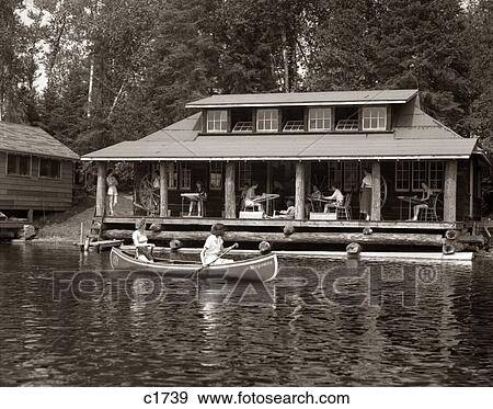 1950S Two Women Paddling In Canoe By Cabin In Lake Algonquin Park Canada Summer Camp Rustic Log Cabin View Large Photo Image Stock Photo - 1950S Two Women Paddling In Canoe By Cabin In Lake Algonquin Park Canada Summer Camp Rustic Log Cabin . Fotosearch
