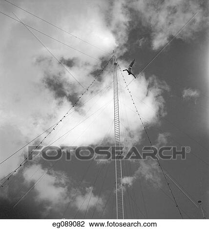 Stock Image - 1950S Woman Diving From High Circus Ladder. Fotosearch