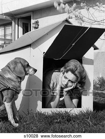 1950S Woman In Doghouse With Dog Sitting Outside On Lawn View Large Photo Image Stock Photo - 1950S Woman In Doghouse With Dog Sitting Outside On Lawn . Fotosearch