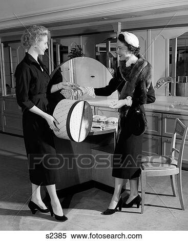 1950S Woman In Hat Stole & Gloves Taking Hatbox From Saleswoman View Large Photo Image Stock Photography - 1950S Woman In Hat Stole & Gloves Taking Hatbox From Saleswoman . Fotosearch