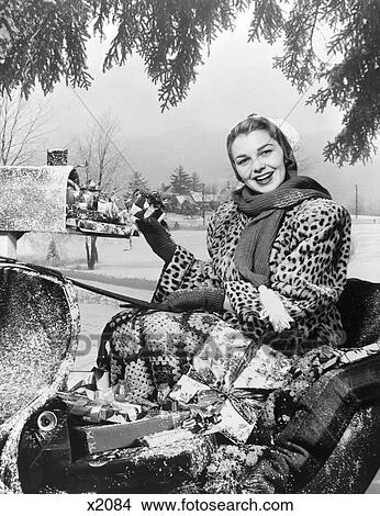 1950S Woman In Sleigh In Leopard Coat At Mailbox With Packages View Large Photo Image Picture - 1950S Woman In Sleigh In Leopard Coat At Mailbox With Packages . Fotosearch
