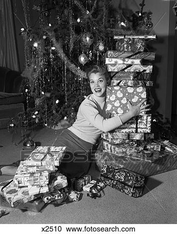 1950S Woman Sitting On Floor In Front Of Xmas Tree Holding Packages View Large Photo Image Stock Image - 1950S Woman Sitting On Floor In Front Of Xmas Tree Holding Packages . Fotosearch