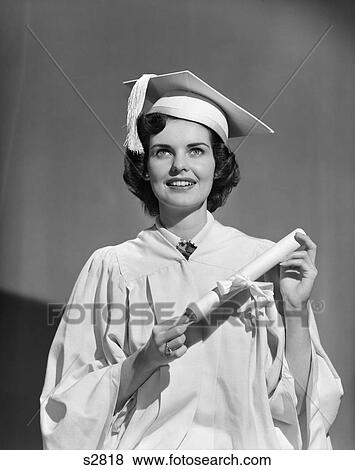 Stock Photo - 1950S Woman Teen Girl White Cap Gown Holding Graduation Diploma . Fotosearch