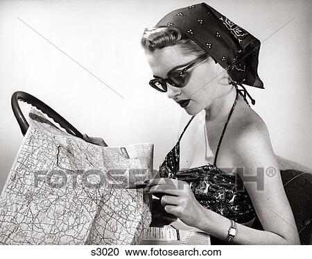 1950S Woman Wearing Bandana Sunglasses & Halter Top Marking Road Map In Mock Car Set-Up View Large Photo Image Stock Image - 1950S Woman Wearing Bandana Sunglasses & Halter Top Marking Road Map In Mock Car Set-Up . Fotosearch