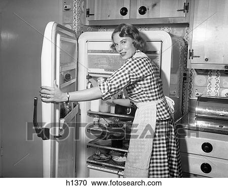 1950S Woman Wearing Gingham Dress And Apron Opening Refrigerator Door View Large Photo Image Stock Image - 1950S Woman Wearing Gingham Dress And Apron Opening Refrigerator Door . Fotosearch