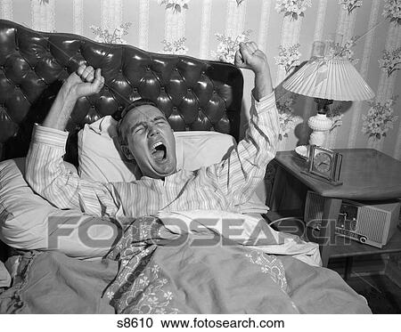 1950S Yawning Stretching Man In Bed With Tufted Leather Headboard View Large Photo Image Stock Image - 1950S Yawning Stretching Man In Bed With Tufted Leather Headboard . Fotosearch