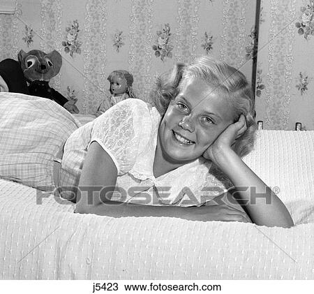 1950S Young Blond Teen Lying On Bed Smiling Head Resting On Hand Stuffed Animal Toys Wallpaper View Large Photo Image Stock Image - 1950S Young Blond Teen Lying On Bed Smiling Head Resting On Hand Stuffed Animal Toys Wallpaper . Fotosearch