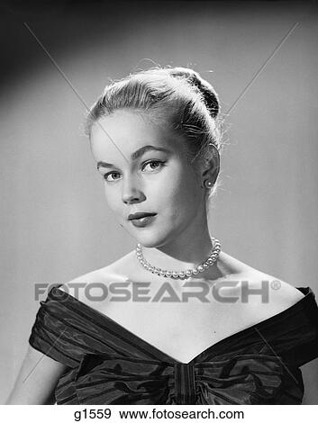 1950S Young Blonde Woman Serious Facial Expression Pearl Necklace Black Satin V Neckline Portrait View Large Photo Image Stock Photo - 1950S Young Blonde Woman Serious Facial Expression Pearl Necklace Black Satin V Neckline Portrait . Fotosearch