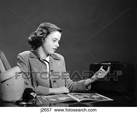 1950S Young Teen Girl Turning Dial On Radio Reading Magazine View Large Photo Image Stock Photo - 1950S Young Teen Girl Turning Dial On Radio Reading Magazine . Fotosearch