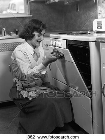 1950S Young Woman Girl Wearing Apron Kneeling Opening Oven Door Kitchen Stovel Cooking View Large Photo Image Stock Image - 1950S Young Woman Girl Wearing Apron Kneeling Opening Oven Door Kitchen Stovel Cooking . Fotosearch