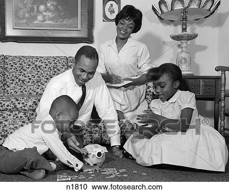 1960S Black Family On Living Room Floor Counting Change In Piggy Bank View Large Photo Image Stock Image - 1960S Black Family On Living Room Floor Counting Change In Piggy Bank . Fotosearch