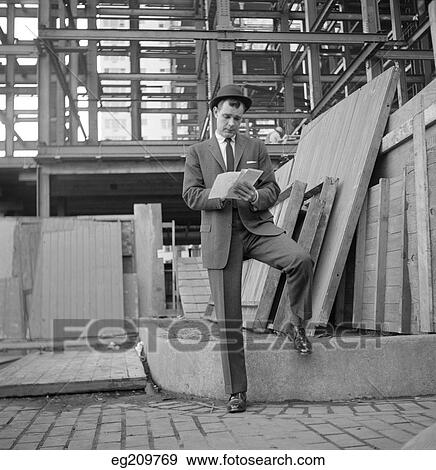 1960S Man Business Suit At Construction Site Making Notes View Large Photo Image Stock Photo - 1960S Man Business Suit At Construction Site Making Notes . Fotosearch