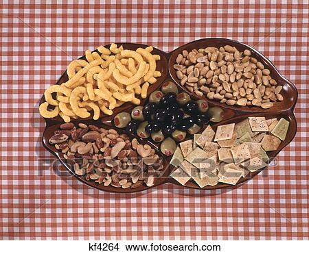 Picture - Cheese Curls, Olives, Cashews, Peanuts, And Crackers In Serving Dish. Fotosearch