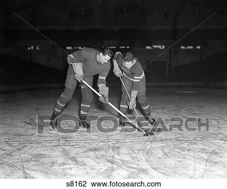Stock Image - Ice Hockey Players Puck 1950S Retro. Fotosearch