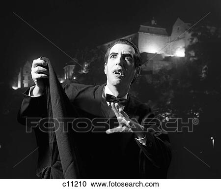 Nighttime Portrait Of Man Wearing Cape And Fangs Dressed As Dracula View Large Photo Image Stock Image - Nighttime Portrait Of Man Wearing Cape And Fangs Dressed As Dracula . Fotosearch