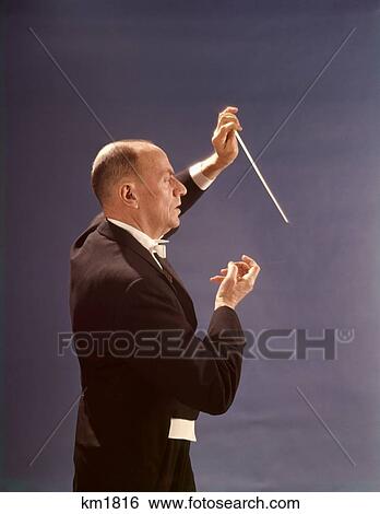 Stock Photograph - 1960 1960S 1970 1970S Band Leader Baton Conductor Maestro Symphony Orchestra . Fotosearch