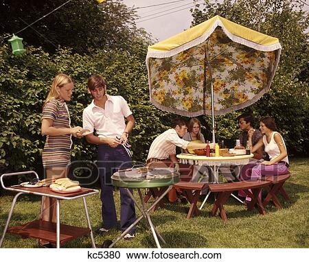1960 1960S 1970 1970S Group Teens Teen Aged Teenagers Boys Girls Backyard Bbq Grill Grilling Table Umbrella Summer View Large Photo Image Stock Image - 1960 1960S 1970 1970S Group Teens Teen Aged Teenagers Boys Girls Backyard Bbq Grill Grilling Table Umbrella Summer . Fotosearch