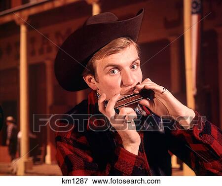 1960 1960S 1970 1970S Man Cowboy Hat Playing Harmonica View Large Photo Image Stock Photo - 1960 1960S 1970 1970S Man Cowboy Hat Playing Harmonica . Fotosearch