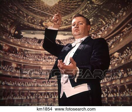 1960 1960S 1970 1970S Orchestra Leader Baton Conductor Conducting Audience Background View Large Photo Image Picture - 1960 1960S 1970 1970S Orchestra Leader Baton Conductor Conducting Audience Background . Fotosearch