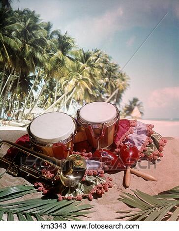 1960 1960S 1970 1970S Still Life Musical Instruments Caribbean Flavor Bongo Drum Trumpet Marachas Tropical Landscape View Large Photo Image Stock Image - 1960 1960S 1970 1970S Still Life Musical Instruments Caribbean Flavor Bongo Drum Trumpet Marachas Tropical Landscape . Fotosearch