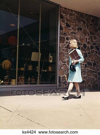 1960 1960S Blond Woman Blue Coat Walking Down Street Window Shopping Looking In Store Shop Windows Retail Retro View Large Photo Image Picture - 1960 1960S Blond Woman Blue Coat Walking Down Street Window Shopping Looking In Store Shop Windows Retail Retro . Fotosearch
