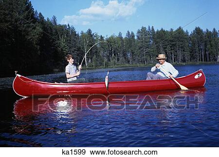 1960 1960S Grandfather & Boy Red Canoe On Lake Fishing Grandson Reeling In Fish Catch Family Families Generations Retro View Large Photo Image Stock Photo - 1960 1960S Grandfather & Boy Red Canoe On Lake Fishing Grandson Reeling In Fish Catch Family Families Generations Retro. Fotosearch