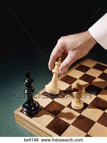 1960 1960S Mans Male Hand Holding Chess Piece Move Moving Checkmate Check Mate Strategy Game Win Retro View Large Photo Image Stock Photo - 1960 1960S Mans Male Hand Holding Chess Piece Move Moving Checkmate Check Mate Strategy Game Win Retro. Fotosearch