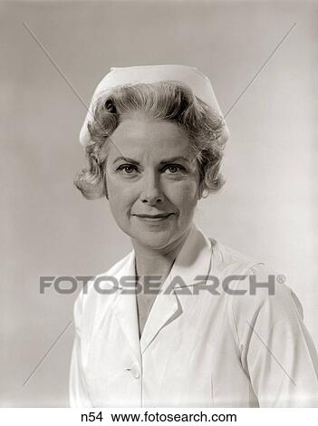 1960 1960S Portrait Smiling But Stern Gray Grey Hair Woman Female Nurse White Uniform Nurses Cap Medical Health Healthcare View Large Photo Image Picture - 1960 1960S Portrait Smiling But Stern Gray Grey Hair Woman Female Nurse White Uniform Nurses Cap Medical Health Healthcare. Fotosearch