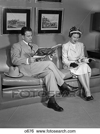 1960 1960S Retro Couple Couch Sofa Sitting Reading Waiting Room Hat Suit View Large Photo Image Stock Photograph - 1960 1960S Retro Couple Couch Sofa Sitting Reading Waiting Room Hat Suit . Fotosearch
