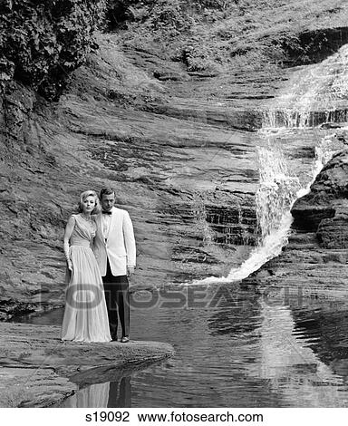 Stock Image - 1960 1960S Retro Couple Waterfall Tuxedo Dress Romance. Fotosearch