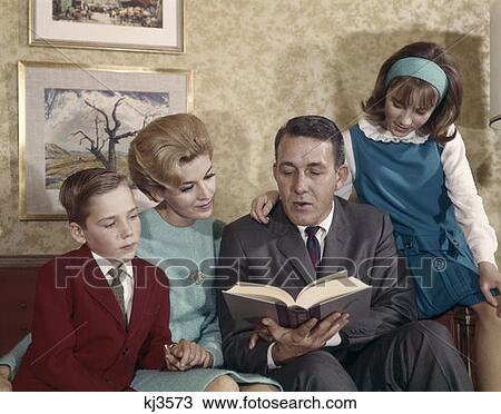 Stock Image - 1960 1960S Retro Family Reading Mother Father Son Daughter. Fotosearch