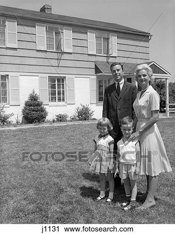Stock Image - 1960 1960S Retro Family Standing By House . Fotosearch